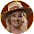 Brooke smiling in her goingforbrooke hat, framed by a gold circle